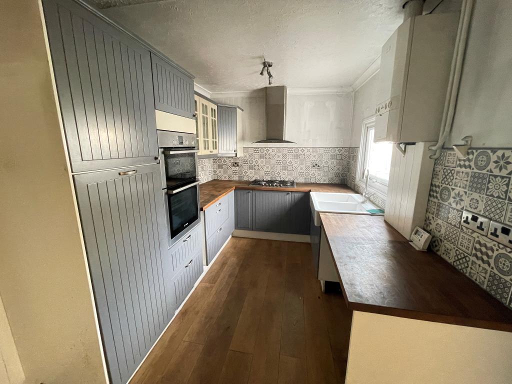 Lot: 88 - FIRE-DAMAGED DETACHED BUNGALOW - Kitchen with fitted units and boiler